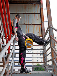 Dark Grey Overalls by TAPE OFF, featuring utility-inspired design, cuffed pant legs, neon pink stitching, and modern workwear-inspired style. Unisex streetwear overalls for industrial fashion and urban looks.