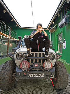 Dark Grey Jumpsuit featuring bomber jacket style, cuffed pants, chunky zipper, and neon accent lining. Perfect for streetwear, industrial fashion, and urban style trends.