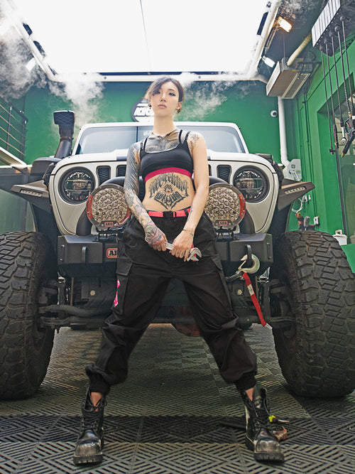 Streetwear Cuffed Cargo Pants in dark grey fabric with neon pink pocket accent, featuring a unisex cuffed pant style and bold prints. Perfect for urban fashion and fashion-forward wardrobes, these lightweight and versatile pants redefine streetwear aesthetics.