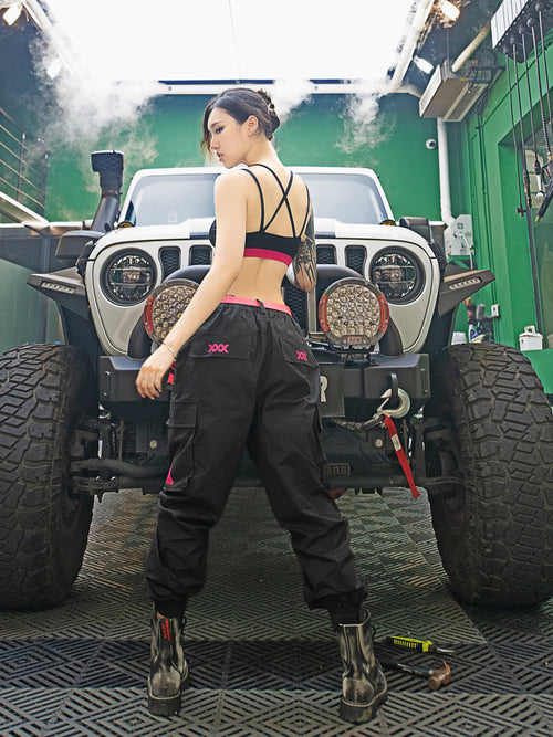 Streetwear Cuffed Cargo Pants in dark grey fabric with neon pink pocket accent, featuring a unisex cuffed pant style and bold prints. Perfect for urban fashion and fashion-forward wardrobes, these lightweight and versatile pants redefine streetwear aesthetics.