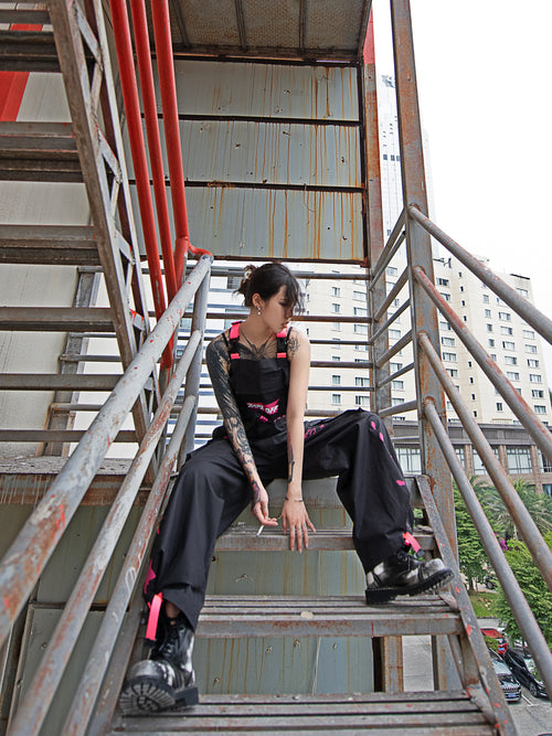 Dark Grey Overalls by TAPE OFF, featuring utility-inspired design, cuffed pant legs, neon pink stitching, and modern workwear-inspired style. Unisex streetwear overalls for industrial fashion and urban looks.