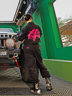 Dark Grey Jumpsuit featuring bomber jacket style, cuffed pants, chunky zipper, and neon accent lining. Perfect for streetwear, industrial fashion, and urban style trends.