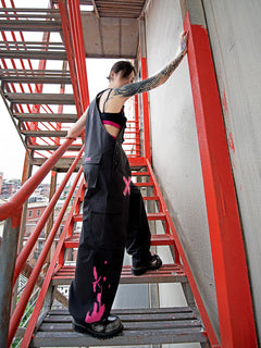 Dark Grey Overalls by TAPE OFF, featuring utility-inspired design, cuffed pant legs, neon pink stitching, and modern workwear-inspired style. Unisex streetwear overalls for industrial fashion and urban looks.