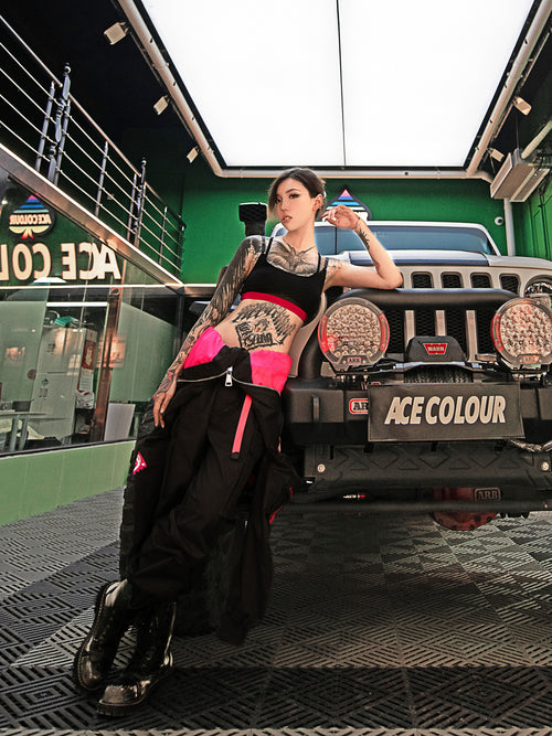 Dark Grey Jumpsuit featuring bomber jacket style, cuffed pants, chunky zipper, and neon accent lining. Perfect for streetwear, industrial fashion, and urban style trends.