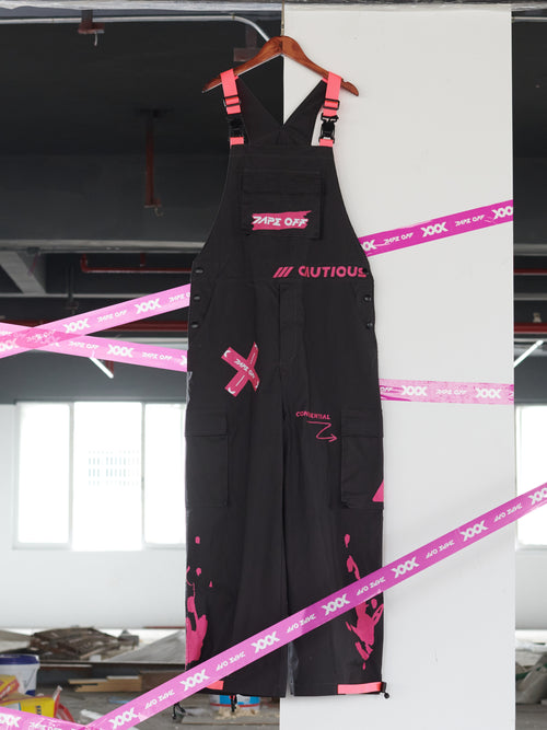 Dark Grey Overalls by TAPE OFF, featuring utility-inspired design, cuffed pant legs, neon pink stitching, and modern workwear-inspired style. Unisex streetwear overalls for industrial fashion and urban looks.