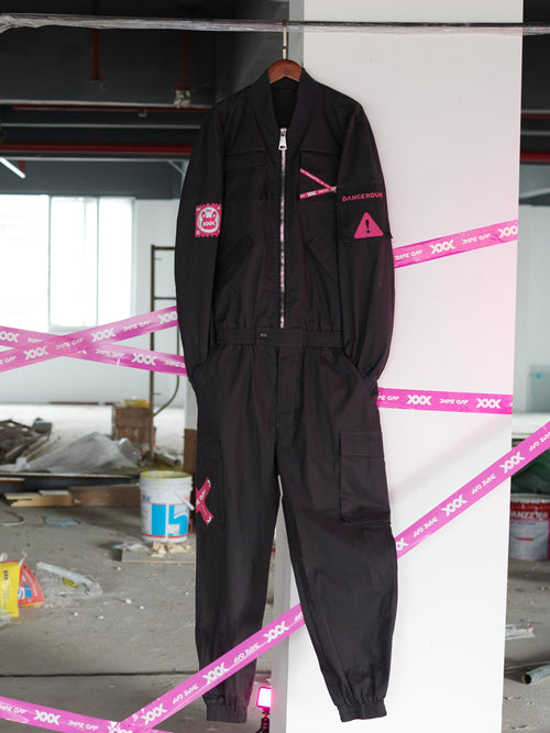 Dark Grey Jumpsuit featuring bomber jacket style, cuffed pants, chunky zipper, and neon accent lining. Perfect for streetwear, industrial fashion, and urban style trends.