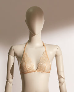 Elegant Celestial Divinity Gilding Bralette set in a shimmering gold tone, featuring delicate eyelash lace and a halter neck design. The bralette is paired with a matching strappy lace thong, both adorned with a luxurious gilding effect. A front closure and minimalist silhouette bring together sophistication, seduction, and comfort in this standout lingerie ensemble from the Pills N Poison collection.