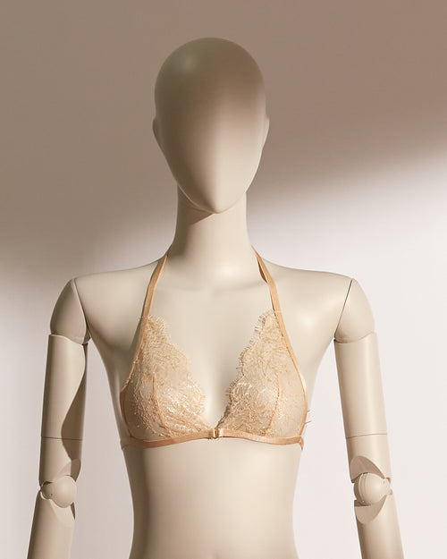 Elegant Celestial Divinity Gilding Bralette set in a shimmering gold tone, featuring delicate eyelash lace and a halter neck design. The bralette is paired with a matching strappy lace thong, both adorned with a luxurious gilding effect. A front closure and minimalist silhouette bring together sophistication, seduction, and comfort in this standout lingerie ensemble from the Pills N Poison collection.