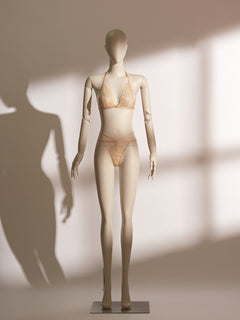 Elegant Celestial Divinity Gilding Bralette set in a shimmering gold tone, featuring delicate eyelash lace and a halter neck design. The bralette is paired with a matching strappy lace thong, both adorned with a luxurious gilding effect. A front closure and minimalist silhouette bring together sophistication, seduction, and comfort in this standout lingerie ensemble from the Pills N Poison collection.