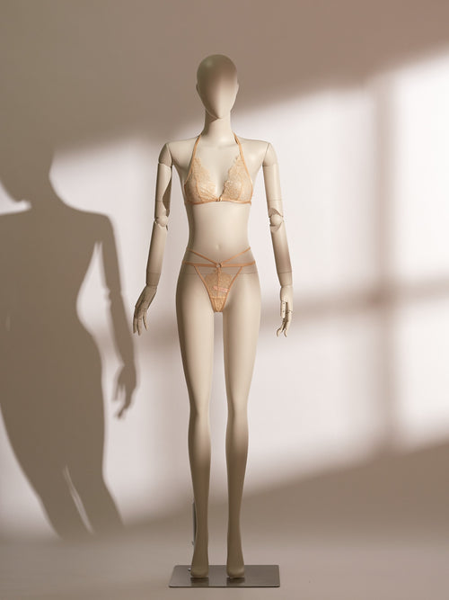 Elegant Celestial Divinity Gilding Bralette set in a shimmering gold tone, featuring delicate eyelash lace and a halter neck design. The bralette is paired with a matching strappy lace thong, both adorned with a luxurious gilding effect. A front closure and minimalist silhouette bring together sophistication, seduction, and comfort in this standout lingerie ensemble from the Pills N Poison collection.