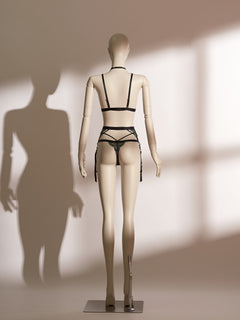 Back view of the luxurious Emerald Obsidian Embroidery Bralette paired elegantly with the matching Embroidery Garter Belt. The bralette showcases vibrant emerald embroidery and delicate shimmer mesh, enhanced by a glamorous detachable rhinestone choker. The intricately designed garter belt features symmetrical embroidered detailing and crossed straps, creating a sophisticated and seductive lingerie ensemble from Pills N Poison.