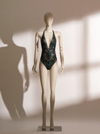 model wearing black sheer lace bodysuit