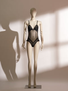 A mannequin displaying a black lace and mesh lingerie bodysuit.