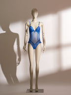 A mannequin displaying a blue lace and mesh lingerie bodysuit.