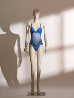 A mannequin displaying a blue lace and mesh lingerie bodysuit.