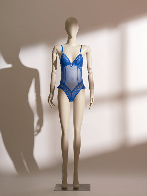 A mannequin displaying a blue lace and mesh lingerie bodysuit.