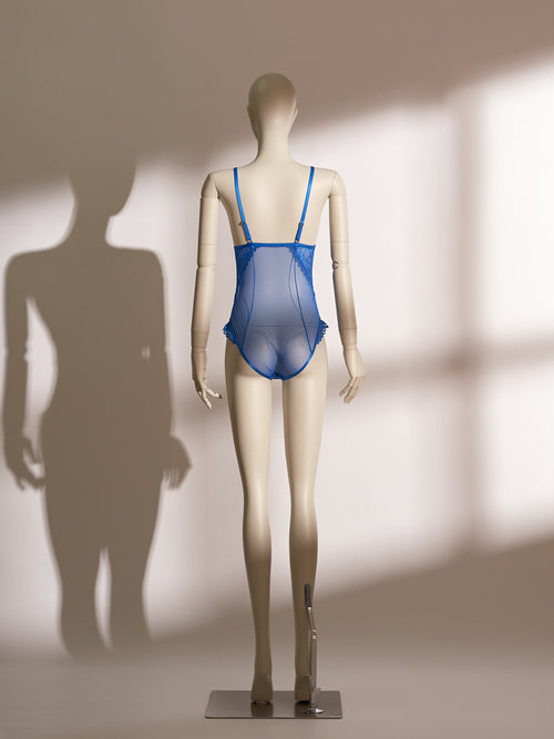 A mannequin displaying a blue lace and mesh lingerie bodysuit.
