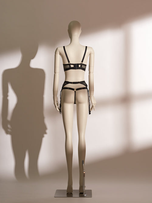 Heartbound lingerie set featuring a black underwire bra with wide straps, heart-shaped hardware, and mesh paneling, paired with a matching thong and a high-waisted lace garter belt with coordinating heart accents and adjustable suspenders. A chic and seductive three-piece set from Pills N Poison, combining comfort, support, and flirtatious detailing.