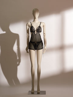 Heartbound Babydoll in sheer black jacquard mesh with lace triangle cups, gold ring detail, and matching mesh panty, designed for adjustable fit and seductive open-back styling.