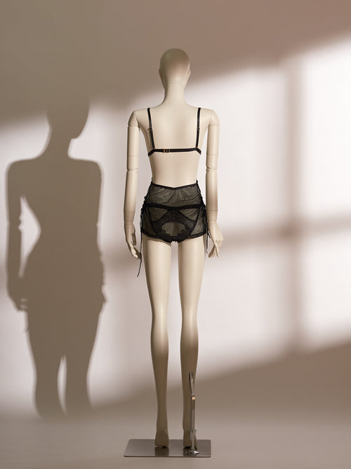 Heartbound Babydoll in sheer black jacquard mesh with lace triangle cups, gold ring detail, and matching mesh panty, designed for adjustable fit and seductive open-back styling.