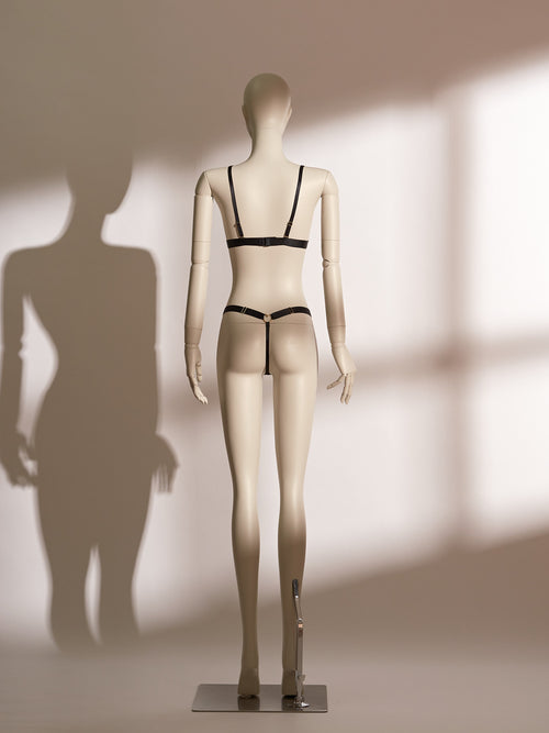 Heartbound Bralette Set in elegant black lace, featuring a wireless bralette with wide supportive straps and a whimsical heart-shaped charm at the center front. Paired with a matching lace thong adorned with fine mesh panels and sleek side straps, this lingerie set blends comfort, playfulness, and refined sensuality from the Pills N Poison collection.