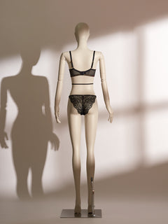 Infernal Grace Underwire Bra Set in black lace, featuring a full-cup design with intricate floral lace, supportive underwire, and adjustable strappy accents that wrap elegantly around the waist. Paired with a matching lace thong, this seductive lingerie set from the Pills N Poison collection combines timeless sophistication with versatile styling.