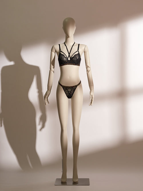 Infernal Grace Underwire Bra Set in black lace, featuring a full-cup design with intricate floral lace, supportive underwire, and adjustable strappy accents that wrap elegantly around the waist. Paired with a matching lace thong, this seductive lingerie set from the Pills N Poison collection combines timeless sophistication with versatile styling.