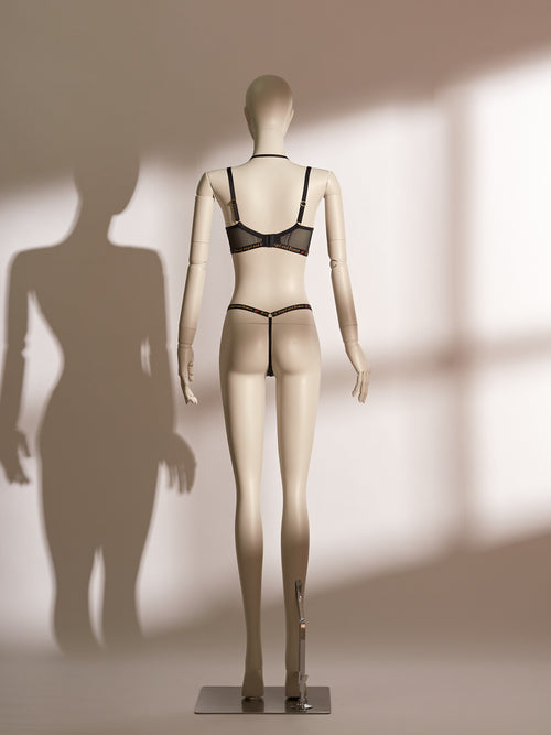 Infernal Grace Underwire Bra Set in black lace, featuring a full-cup design with intricate floral lace, supportive underwire, and adjustable strappy accents that wrap elegantly around the waist. Paired with a matching lace thong, this seductive lingerie set from the Pills N Poison collection combines timeless sophistication with versatile styling.