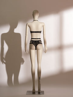 Black lace Isadora Halter Bra Set on mannequin, featuring wide halter straps, underwire bra with front clasp, high-waisted thong with strappy harness design and gold-tone hardware, styled for seductive elegance.