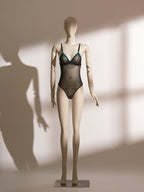 Nocturne Tassel Ouvert Bodysuit with sheer mesh, emerald satin detailing, and provocative tassel accents for seductive elegance