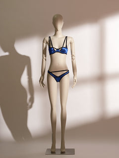 Electric blue satin underwire bra and thong set with bold black trim and strappy details, designed for petite figures and modern everyday wear.
