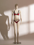 Red underwire bra and matching thong lingerie set with black trim and double straps, featuring a sheer fabric finish and asymmetric waistband, designed for petite body types.