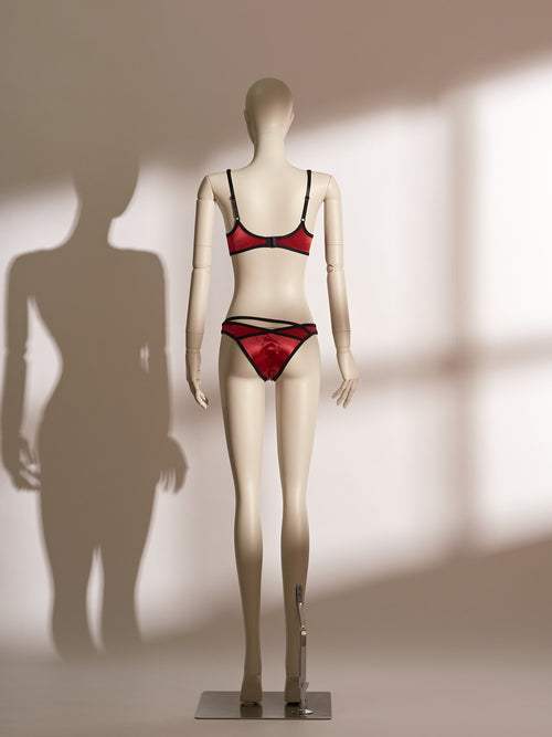 Red underwire bra and matching thong lingerie set with black trim and double straps, featuring a sheer fabric finish and asymmetric waistband, designed for petite body types.