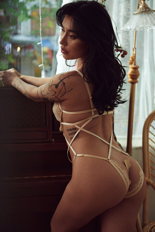 Celestial Divinity Gilding Underwire Teddy by Pills N Poison, featuring intricate gilded lace, a chic strappy design, supportive underwire, and an ouvert open crotch detail. This sensual and seductive golden bodysuit embodies avant-garde design and hot lingerie elegance, perfect for adult occasions.