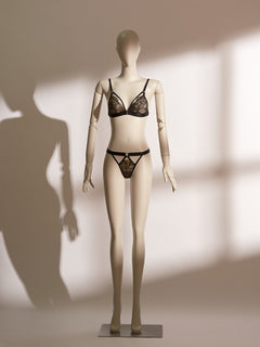 Black and gold lace bralette and thong set with wireless design, adjustable straps, low-rise strappy knicker, and gilded detailing for a refined and seductive lingerie look.