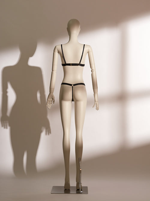 Black and gold lace bralette and thong set with wireless design, adjustable straps, low-rise strappy knicker, and gilded detailing for a refined and seductive lingerie look.