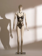 Celestial Chains Black Ouvert Bodysuit with intricate black lace, gold detailing, and provocative open-cup design for daring elegance