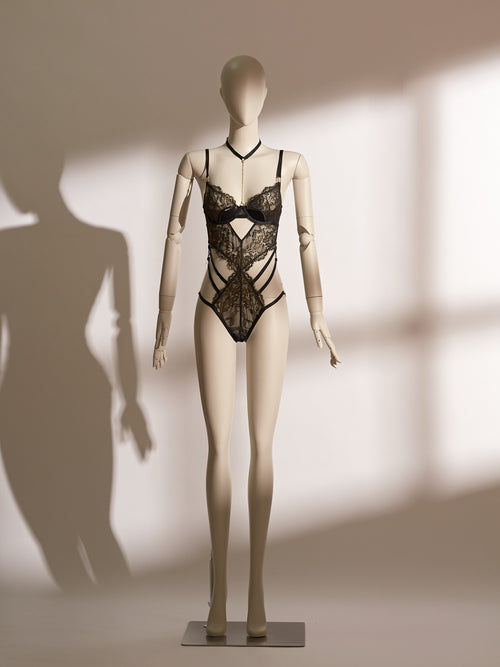 Celestial Chains Black Ouvert Bodysuit with intricate black lace, gold detailing, and provocative open-cup design for daring elegance