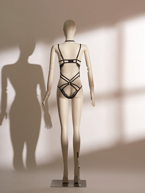 Celestial Chains Black Ouvert Bodysuit with intricate black lace, gold detailing, and provocative open-cup design for daring elegance