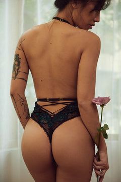Emerald Teddy Lingerie featuring two-tone emerald and black lace, high-cut design, V-shaped front, and adjustable halter and back straps. A sensual bodysuit from a premium lingerie brand, perfect for adults seeking hot lingerie with elegance and sophistication.